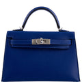 Blue handbag with a silver clasp on a white background