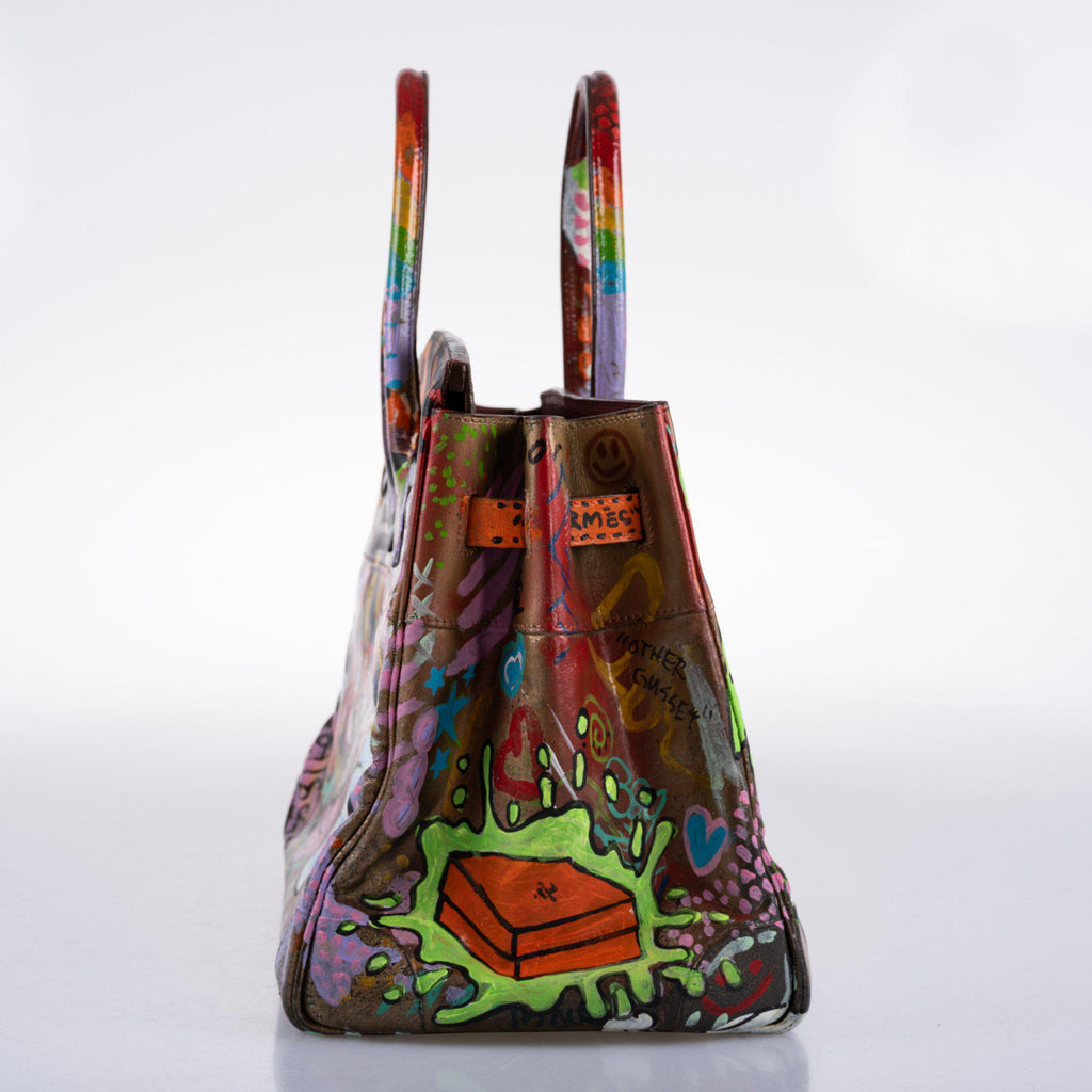 Closeup of hand-applied graffiti paint on Box leather surface
