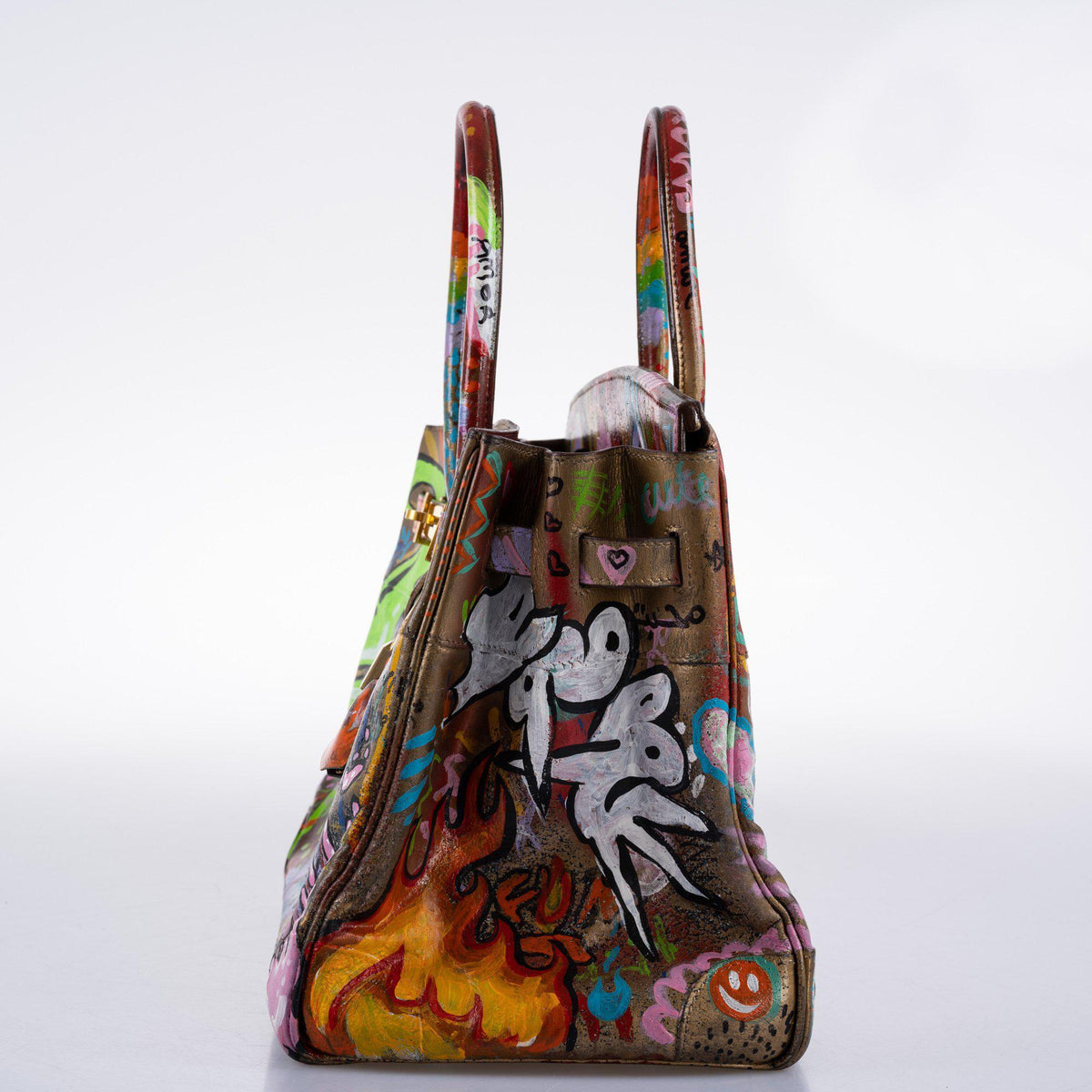 Word “Love” in stylized fonts painted across Birkin bag front